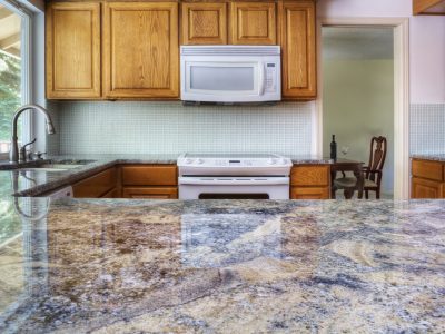 Granite counter reflecting kitchen cabinets